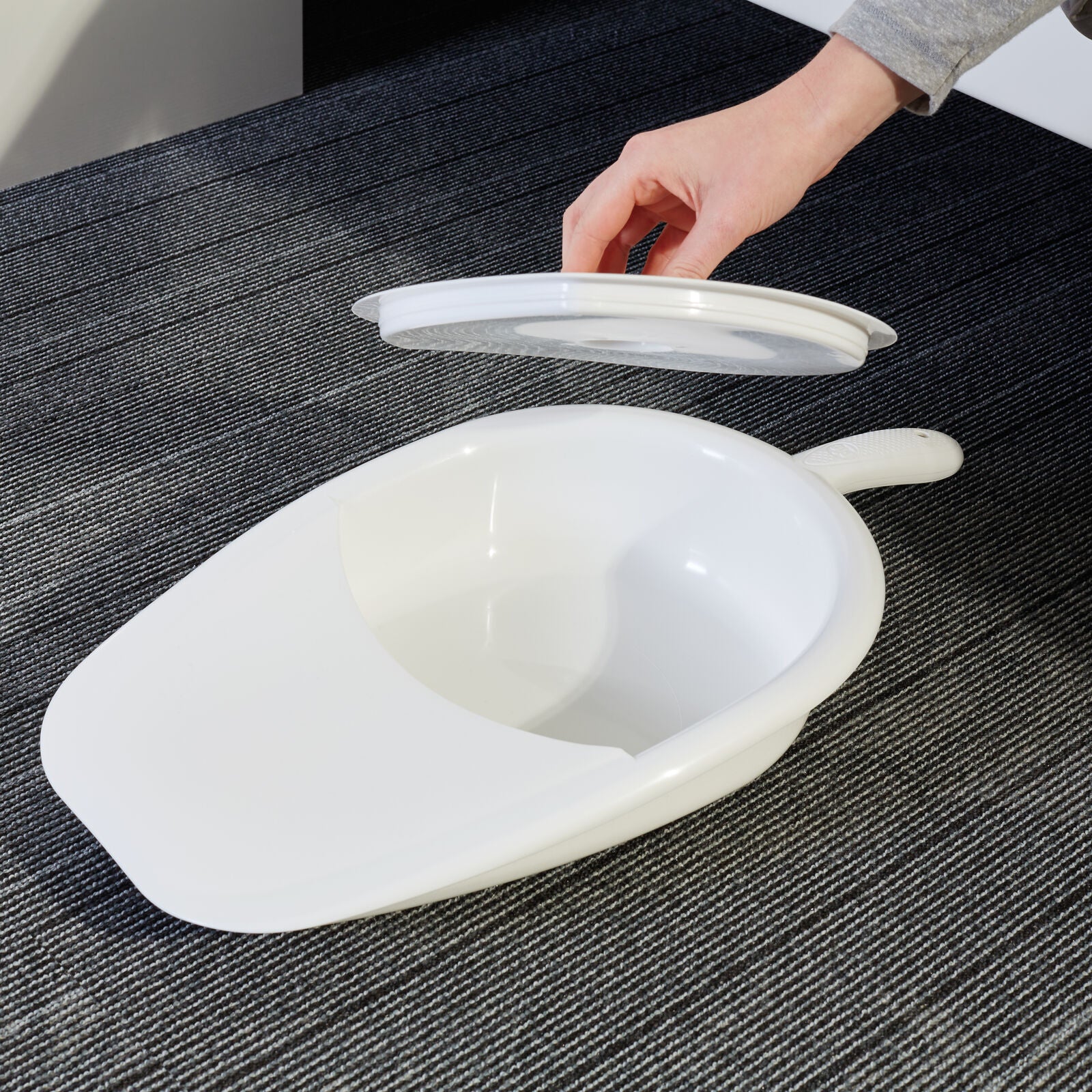 Vitility bedpan with lid for bedroom use, single piece, ergonomic design for comfortable patient care.