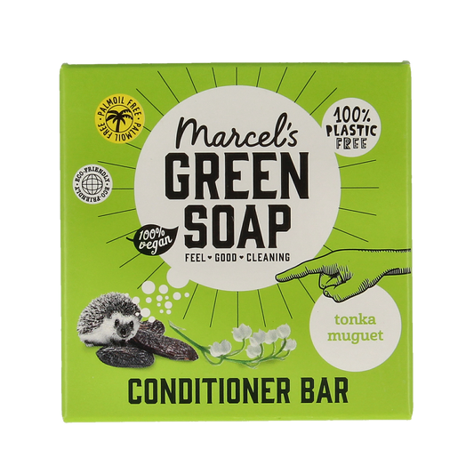 Marcel's Green Soap conditioner bar with tonka and muguet, 60g, for hair care, shown in a natural setting with the product packaging.