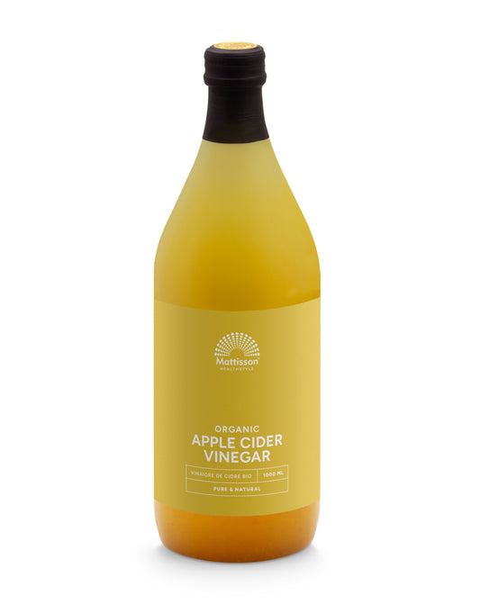 Glass bottle of Mattisson organic apple cider vinegar with a label, 1-liter size, used for drinks and cooking.