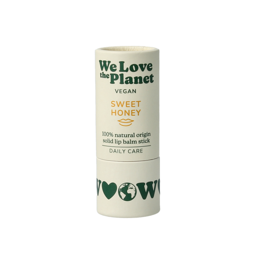 We Love The Planet vegan honey lip balm in a 7g tube, nourishing lip care with sweet honey scent and natural ingredients.