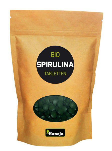 Hanoju Spirulina bio tablets, herbal supplement, close-up of green spirulina tablets in a plastic bottle, natural nutrition product.