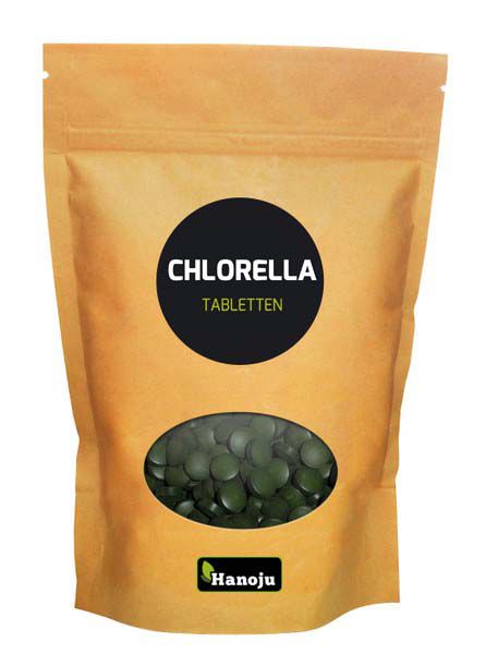 Hanoju Chlorella tablets in paper bag, showing green tablets packed for dietary supplement use.