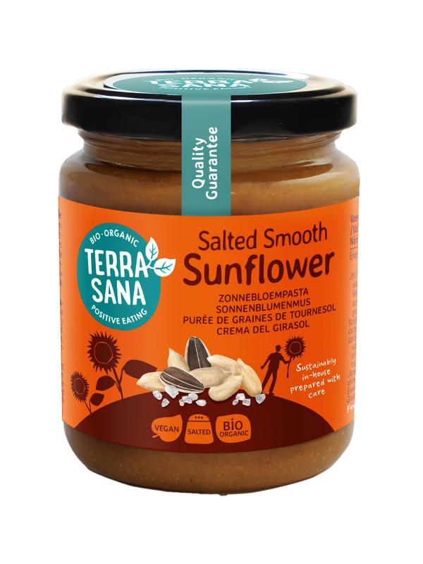 Organic TerraSana sunflower seed spread on bread, showcasing a jar of TerraSana Zonnebloempasta bio 250g with a spoon and fresh bread.
