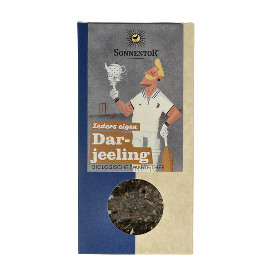 Organic Sonnentor Darjeeling black loose tea in a 100g package, showcasing dried tea leaves in a natural setting.