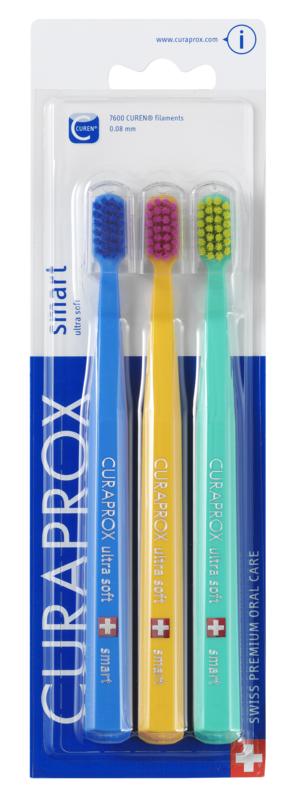 Three Curaprox CS smart ultra soft toothbrushes in a 3-pack, showing the toothbrush heads and handles with soft bristles.