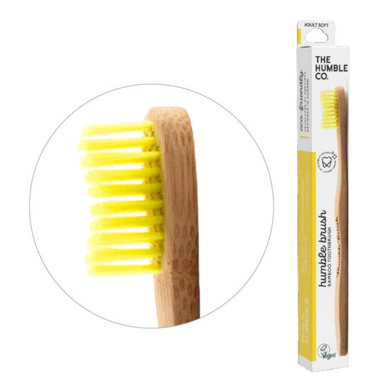 The Humble Co bamboo adult toothbrush with soft yellow bristles, eco-friendly design, and wooden handle.