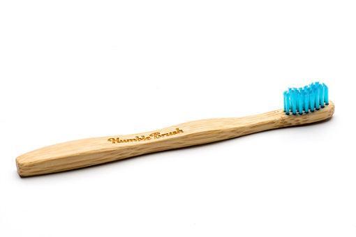 The Humble Co bamboo kids toothbrush with soft blue bristles, designed for gentle brushing, displayed on a white background.