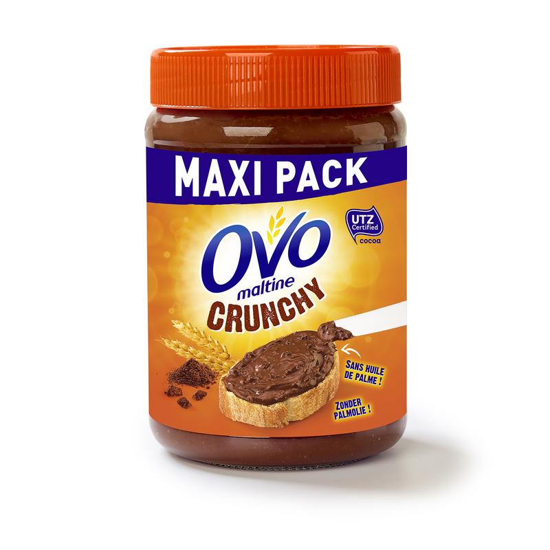 Ovomaltine Crunchy Cream spread on bread, 660g jar, with a spoonful showing the crunchy chocolate malt flavor.