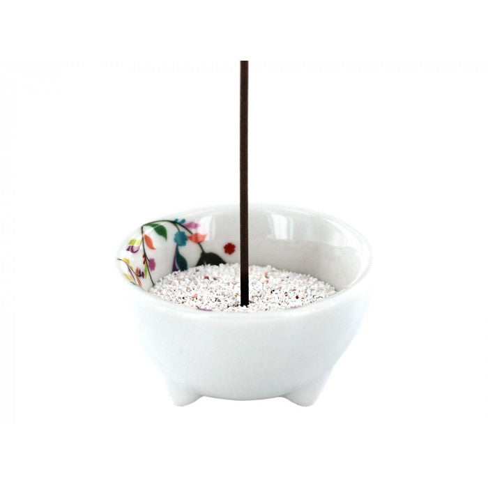 Volatile flora incense burner for burning incense sticks, featuring a decorative floral design on a ceramic holder.